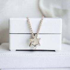 Elegant Star of David Necklace: Timeless symbol of faith, crafted with precision. Pictured at 16" and 18" adjustable lengths. Sterling Silver 14K Gold Plate 16" + 2" 10mm diameter Sugar Bean Jewelry's complimentary packaging adds an extra special touch to your jewelry purchase. Our dainty glass bottle and pouch will showcase your piece with style and sophistication. Silver Star Of David Necklace For Formal Occasions, Formal Silver Star Of David Necklace, White Star-shaped Clavicle Chain Necklace, White Gold Star Necklace With Polished Finish, Formal White Gold Star Of David Necklace, Yellow Gold Star Necklace With Adjustable Chain, White Star-shaped Jewelry With Adjustable Chain, Silver Star-shaped Necklace For Formal Occasions, White Gold Star Of David Polished Jewelry