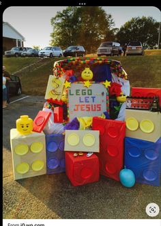 a car decorated with legos and toys in front of a sign that says i go let jesus