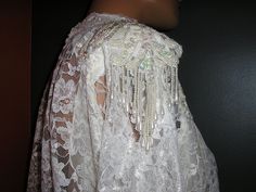 "Vintage, early 80s, victorian style, blouson, cream lace and taffeta, wedding, formal, gown, dress. Red union label. Bat wing sleeves. Sized 9/10. Outer shell 50% rayon, 50% poly. Lining 100% acetate. Waist and long drop in the back are taffeta, as is the lining. Open back. Removable shoulder pads. The beading is removable, the beaded shoulder \"fringe\" can be cut off as well. Excellent condition, no flaws or damage. Measurements: shoulders across front: 18\" chest across front: 18\" waist acr Victorian Fitted Wedding Lace, Vintage White Lace For Party, Vintage Fitted Lace For Wedding, Vintage Lace With Lace Bodice For Weddings, Fringe Wedding Dress, Wedding Formal Dress, Formal Dress Gown, Bat Wing, Wedding Formal