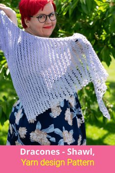 a woman with red hair and glasses wearing a white crochet shawl