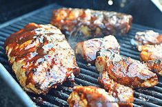 bbq meat is being cooked on the grill