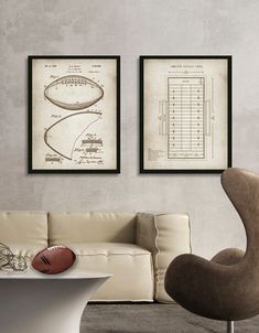 a living room with two framed footballs on the wall