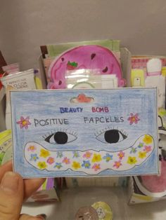 a person holding up a card that says beauty bomb positive fapkies on it