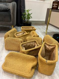 four yellow purses sitting on the floor in front of a couch