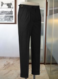 When it's about formality, the black trousers reign supreme. Crafted from wool lycra blend, our Stretch Black Wool Highland Trousers boast plenty of charm and sophistication that you can flaunt at any formal or important events.  
 
 Look Includes   Stretch     Black     Wool  Fabric  Cross Pocket  Forward 2 Pleats  Side Tabs (No Loops)- Arrow Shape  Bottom Cuff (1.5")  Two Welted Back Pockets on Trousers   You can change the look during customization if required. 
 
 Lining: Viscose, Dry Clean. Green Linen Trousers, Black Wool Fabric, Blue Tweed Jacket, Black Tuxedo Suit, Grey Wool Suit, Fabric Cross, Casual Office Wear, Scottish Fashion, Blue Chinos