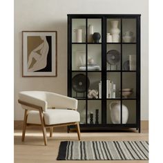 a white chair sitting in front of a glass cabinet