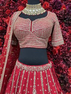 Go all out in this whimsical lehenga, studded with precious mirror, pearl, stone, embroidery work, which is sure to bring out the innate grace and grandeur in you! Color - Crimson Red Fabric & Work Style - - Silk blouse: mirror, pearl, stone, embroidery work. - Soft net lehenga: mirror, pearl, stone, embroidery work. - Soft net dupatta: embroidery work. Details - - Assured quality - Wash care instruction: Dry clean only. - Slight variation in color is possible due to digital photography. Wedding Embellished Blouse Piece In Chinon, Embellished Blouse Piece For Diwali Wedding, Embellished Blouse Piece For Wedding And Diwali, Floor-length Embellished Blouse For Wedding, Elegant Navratri Choli With Mirror Work, Elegant Embellished Choli For Navratri, Embellished Blouse Piece For Wedding And Festivals, Designer Wear Embellished Choli With Traditional Drape, Festive Kundan Lehenga With Zari Work