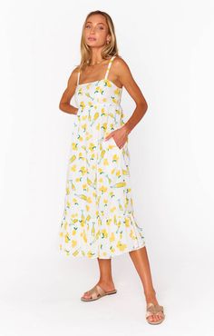 Twist and turn in this Summer Fling Midi! This flowy dress is adorned with a square neckline and comfortable smocked back. Our personal favorite part of this dress is the adorable summer lemon print design. Dress it up with a pair of strappy heels or... Summer Fling, Formal Dress Shops, Romper And Jacket, Graphic Tee Dress, Midi Dress Summer, Limoncello, Show Me Your Mumu, Dress With Cardigan, Flowy Dress