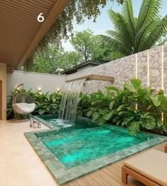 an indoor pool with water features in the center, surrounded by greenery and trees