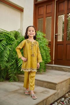 2-Piece Embroidered Suit for Girls (shirt & trouser only) : A classic Intricately crafted design and captivating details make this two-piece staple a perfect style statement for you and your little one. Description -- Kameez (Shirt) : Paper Cotton shirt engraved with floral embroidered details and mirror embellishment. Lining included. -- Shalwar (Trouser) : Green Pants. General Care Instruction : Should be hand washed and hung to dry. Color may bleed so please be mindful of other items with it. Long Sleeve Sets For Eid, Eid Long Sleeve Matching Sets, Long Sleeve Matching Set For Eid, Embroidered Cotton Pant Set For Eid, Festive Cotton Pant Set With Embroidered Border, Festive Embroidered Cotton Pant Set, Cotton Sets With Floral Embroidery For Eid, Floral Embroidered Cotton Sets For Eid, Long Sleeve Sets With Embroidered Border For Diwali