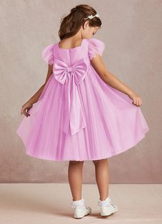 Kalio is our adorable tulle and matte satin flower girl dress. She features a square neckline that is framed with charming short flutter sleeves. She has an empire waist that offers comfort and ease of movement. The flowy A-line skirt adds whimsy while the removable bow gives this dress versatility. This dress is not only perfect for a flower girl at a wedding but also versatile enough for other special occasions. Pink Flower Girl, Satin Flower Girl Dress, Pink Flower Girl Dresses, Tulle Flower Girl, Satin Flowers, Dress Flower, Candy Pink, Matte Satin, Flower Girl Dress