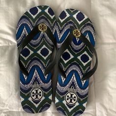 Tory Burch Sandals With A Slight Heel Tan Cushioned Sandals For Beach, Tan Round Toe Sandals For Beach, Casual Tan Flat Flip Flops, Casual Tan Flip Flops For The Beach, Tan Flat Flip Flops For Vacation, Tan Vacation Flip Flops, Tory Burch Heels, Tory Burch Sandals, Tory Burch Shoes