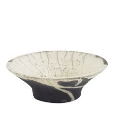 a black and white bowl sitting on top of a table