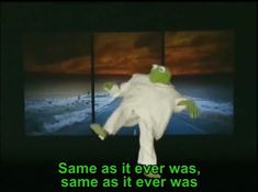 a green frog is dancing in front of a television with the caption same as it ever was, same as it ever was