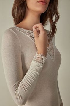 Long-sleeved modal cashmere ultralight shirt enhanced with lace. Feminine Long Sleeve Tops For Layering, Elegant White Blouse For Loungewear, Viscose Long Sleeve Tops For Daywear, Elegant White Viscose Top, Elegant Long Sleeve Tops For Layering, Long Sleeve Viscose Tops For Daywear, Elegant Stretch Blouse For Daywear, Spring Daywear Modal Tops, Casual Modal Tops For Daywear