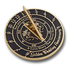 a pen sitting on top of a black and gold sundial