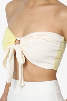 Embrace a playful yet chic vibe with our Colorblock Bow Knot Tie Front Bandeau.This eye-catching Strapless Crop Top features a bold colorblock design, accented with a charming bow knot for a touch of femininity.The ribbed texture adds a modern twist, making it perfect for pairing with over a tank top and high-rise jeans or flowy maxi skirts.Ideal for sunny days out or stylish evenings, it's a versatile addition to your wardrobe. Add this must-have top to your collection and turn heads with every stepColorblock design bandeau, ideal for summer parties or beach outgoingBow knot tie front detail, Double-lined front, No wireRibbed texture for a trendy look, perfect for high waisted jeans or skirtsStrapless style for a chic and stylish outfitModel size : 5'3" height, 33" bust, 24" waist, 34" hi Summer Yellow Tops With Contrast Color, Yellow Summer Tops With Contrast Color, Yellow Tops With Contrast Color For Summer, Fitted Crop Top With Contrast Color For Summer, Summer Fitted Color Block Crop Top, White Bow Crop Top For Summer, White Summer Color Block Tops, Fitted Color Block Crop Top For Summer, Summer Cotton Color Block Crop Top