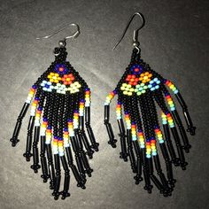 These Beautiful Earrings From Artisan Mxico Are A True Work Of Art. The Colorful Beads And Delicate Fringe Create A Boho Folk Style That Will Make Any Outfit Pop. Handmade In Mexico, These Earrings Showcase The Country's Rich Cultural Heritage. The Earrings Feature A Mix Of Black And Multicolored Beads, Adding A Playful Touch To Any Outfit. The Dangling Fringe Adds Movement And Texture, Making Them Perfect For A Night Out Or A Casual Day. Please See Photographs For A Better Understanding Of The Yellow Beaded Earrings With Ear Wire For Festivals, Black Dangle Jewelry For Beach, Artisan Black Jewelry For The Beach, Multicolor Dangle Jewelry With Black Beads, Black Dangling Beads Jewelry For Beach, Beach Jewelry With Black Dangling Beads, Black Beach Jewelry With Dangling Beads, Bohemian Black Teardrop Beaded Earrings, Unique Black Beaded Dangle Earrings