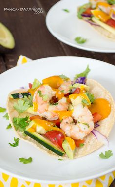 shrimp and avocado tacos are served on tortillas