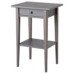 a small grey table with one drawer