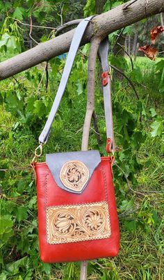 Hand Made Red Leather Tote Type Bag of leather with a stiffer or somewhat firm temper. This bag has an adjustable shoulder or cross body strap to 39″ in the prettiest slate gray leather and matching red leather on the buckle side. This bag is approximately 9.3/4″ Tall x 8.3/4″ wide at the top and 2″ across at the bottom. It has a magnetic top flap closure of the same gray leather as the strap, that also secures the outside pocket. Brass hardware. There is one hanging pock Red Leather Saddle Bag Shaped As Satchel, Red Leather Saddle Bag In Satchel Shape, Red Leather Saddle Bag With Detachable Strap, Red Leather Satchel Saddle Bag, Red Crossbody Satchel With Leather Lining, Red Leather Crossbody Shoulder Bag, Red Leather-lined Crossbody Satchel, Red Leather Lining Crossbody Satchel, Red Leather Rectangular Saddle Bag