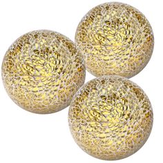 three gold colored glass balls sitting next to each other