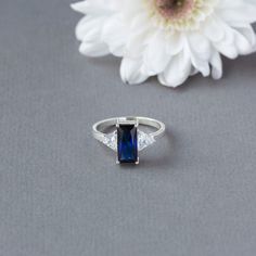 Baguette cut Sapphire and moissanite gold ring | Etsy Dazzling Square Cut Wedding Ring, Sapphire Baguette Cut Diamond Ring, Dazzling Baguette Cut Diamond Promise Ring, Elegant Baguette Cut Topaz Promise Ring, Sterling Silver Radiant Cut Ring For Promise, Elegant Baguette Cut Topaz Ring Gift, Sterling Silver Radiant Cut Promise Ring, Square Cut Cubic Zirconia Diamond Ring For Wedding, Square Cut Cubic Zirconia Wedding Ring