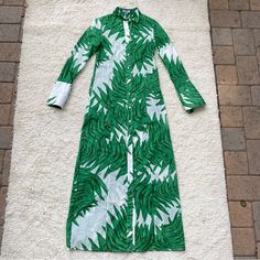 Whether Worn Loose, Layered Over A Bathing Suit Or Paired With White Jeans, This Versatile Shirt Dress Combines Elevated Details Like Oversized Cuffs, With An Iconic Print That Conjures Swaying Fronds In Sun-Washed Destinations Ranging From The Seychelles To Saint-Tropez. Posted The Flaws In Last Picture, It Is A Very Small Tiny Hole. Green Fitted Shirt Dress For Vacation, Fitted Green Shirt Dress For Vacation, Green Printed Daywear Dresses, Printed Green Dresses For Daywear, Green Printed Dress For Daywear, Long Sleeve Silk Shirt Dress For Summer, Silk Long Sleeve Midi Dress For Vacation, Long Sleeve Silk Midi Dress For Vacation, Elegant Green Button-up Maxi Dress