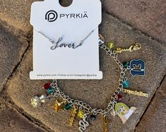 a bracelet with charms on it sitting next to a tag that says pyrikia