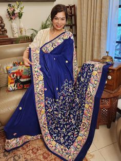 Update! - Zynah covered by LBB - https://lbb.in/bangalore/zynah-designs-handloom-sarees/ Elevate your style quotient with our Navy Blue Pure Crepe Silk Hand Embroidered Parsi Gara Saree, a stunning piece of authentic vintage art that is sure to make you stand out. Adorned with intricate nature-inspired motifs and multi-color thread embroidery, this saree boasts of a beautiful combination of small colorful floral butis in the body. The saree features a double layer of embroidery to create a uniqu Blue Bohemian Blouse Piece With Zari Work, Bohemian Blue Raw Silk Traditional Wear, Blue Silk Saree With Floral Embroidery, Blue Pallu Embroidered Raw Silk Fabric, Blue Raw Silk Embroidered Fabric With Pallu, Blue Embroidered Pallu Raw Silk Fabric, Designer Blue Embroidered Saree, Blue Bohemian Raw Silk Saree, Blue Saree With Floral Embroidery In Traditional Drape