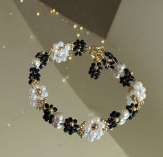 This beautiful white and black floral bracelet is handmade. Would be a great gift for her, a wedding gift. You can make them into matching bridesmaid, bracelets, party favors, and just an every day accessory. If you would like I can customize any colors on the bracelet just send me a message. I offer lengths 5 inches to 9 inches. If you need another size, please let me know and I would love to make it for you. If you do not like the clasp I have other options just let me know when I can send you Black Flower Shaped Beaded Bracelets, Black Flower Beaded Bracelets For Gift, Black Flower Shaped Beaded Bracelets For Gift, Handmade Black Flower Bracelets, Black Flower Beaded Bracelets, Bridesmaid Bracelets, Matching Bridesmaids, Seed Bead Bracelet, Floral Bracelet