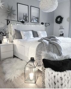 a bedroom with white bedding and decorations