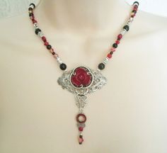 "This beautiful necklace has red glass beads, black glass beads, seed beads, pewter silver accent beads and a silver plated pendant with red rose setting, silver plated accent, pewter silver drop and rhinestone accents. 18\" long. Silver plated toggle clasp." Victorian Necklace, Jewelry Gothic, Nouveau Jewelry, New Plymouth, Neo Victorian, Art Nouveau Jewelry, Rose Necklace, Victorian Jewelry, Gothic Jewelry