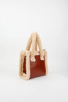 Elevate your style with our Faux Fur Tote Bag--a chic blend of faux fur and faux leather. Featuring a removable, adjustable shoulder strap and a secure zip closure, this bag is both trendy and functional. The single compartment easily fits your A5 notebook, phone, keychain, card holder, small wallet, and makeup essentials. Carry it effortlessly by hand, on the shoulder, or cross-body. Explore the latest in Brown Fluffy Bags and shop now for the must-have Brown Fur Tote Bags! Details: Faux fur Faux leather Zip closure Removable and adjustable shoulder strap Single compartment A5 notebook, phone, keychain, card holder, small wallet, make-up materials fit. It can be used in the hand, on the shoulder and cross-body. Size: Width: 22 cm (8,6 inches) Length: 24 cm (9,4 inches) Depth: 10 cm (3,9 i Faux Leather Satchel Bags With Handles, Faux Leather Satchel With Handles, Large Capacity Faux Leather Bags In Rectangular Shape, Large Capacity Rectangular Faux Leather Bag, Rectangular Faux Leather Bag For Daily Use, Rectangular Faux Leather Bag For Everyday Use, Rectangular Faux Leather Bag With Top Carry Handle, Brown Faux Leather Bags With Top Carry Handle, Brown Faux Leather Bag With Top Carry Handle