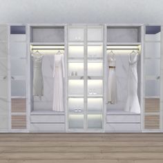 an empty white closet with clothes hanging on the walls and wooden flooring in front of it