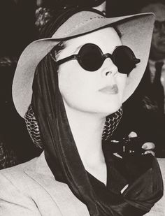 a woman wearing sunglasses and a hat