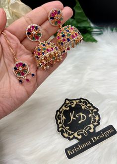 Beautiful American Diamond Jhumki Earrings with Tikka| Perfect for Wedding and Party wear occassion | High end AD earrings| gifts for her| Pink, Multi ad jhumka tikka set ⭐️Made with the Finest & High End Quality.  ⭐️ Set comes with Jhumki/Jhumka style earrings and mang tikka. Material- American Diamond Colors- -Multi - Pink High End Quality 100% Satisfaction Guarantee: Long Lasting Plating, High-Quality Stones. Perfect for any occassion-Western, Indian and Casual day looks.  Care: It is advisab Festive Hand Set Jhumkas For Party, Multicolor Cutdana Danglers For Celebration, Fusion Kundan Jhumkas For Party, Fusion Style Kundan Jhumkas For Party, Fusion Style Party Chandbalis With Hand Set, Multicolor Tilla Chandbalis For Party, Hand Set Kundan Jhumkas For Party, Party Chandbali Jhumkas Hand Set, Hand Set Chandbali Jhumkas For Party