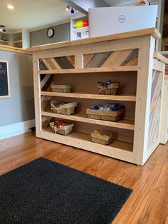 a kitchen island made out of pallet wood with baskets on the top and bottom