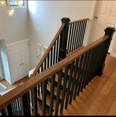 the stairs in this house are made of wood and wrought iron with black handrails