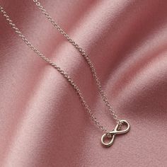 The dainty Sterling Silver Mini Infinity Charm Necklace is handcrafted from sterling silver in our Brighton workshop. The infinity symbol is seen to represent eternal love or everlasting friendship and makes a gorgeous gift for any occasion, perfect for birthdays, anniversaries, bridesmaid gifts or simply as a token of love and friendship. The Mini Infinity Charm Necklace features a delicate infinity pendant suspended from an extra fine chain, we love the contemporary look of the chain threaded Dainty Infinity Necklace As Gift For Her, Silver Infinity Necklace With Delicate Chain, Minimalist Sterling Silver Infinity Necklace, Silver Infinity Dainty Necklace, Silver Dainty Infinity Necklace, Silver Infinity Necklace In Dainty Style, Dainty Silver Infinity Jewelry, Dainty Infinity Silver Jewelry, Adjustable Sterling Silver Infinity Necklace