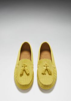 Hugs & Co. yellow tasselled loafer driving shoes for women. Moccasin style driving loafers in luxurious yellow suede upper embossed with a Gecko print pattern and lined with a soft leather for extra comfort. Made in Portugal 100% Suede Upper featuring a 100% Leather Lining Rubber studded sole Luxury Slip-on Tassel Loafers With Textured Sole, Yellow Leather Slip-on Loafers, Yellow Slip-on Moccasins With Rubber Sole, Yellow Formal Loafers For Spring, Formal Yellow Loafers For Spring, Yellow Round Toe Loafers For Formal Occasions, Yellow Slip-on Loafers For Formal Occasions, Yellow Suede Slip-on Loafers, Luxury Suede Loafers For Spring