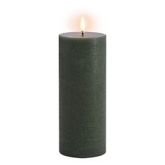 a green pillar candle with a single lit candle in the middle on a white background