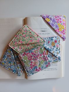 four different colors of fabric folded on top of each other in an open book with the title, the bloom