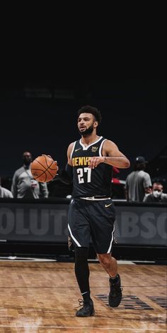 a basketball player dribbling the ball during a game