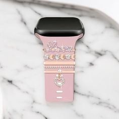 the pink apple watch band is adorned with swaroes and heart - shaped jewels