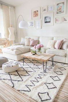 a living room filled with furniture and pictures on the wall