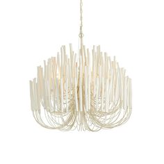 a white chandelier hanging from the ceiling with wooden sticks attached to each light fixture