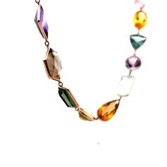 This exquisite modern necklace is crafted from 14 karat yellow gold, creating a luxurious and elegant piece that is sure to spark a conversation. The long piece features a series of multi-gemstone bezel set stones, with a total of 91.52 carats of citrine, 89.96 carats of aquamarine, 80.66 carats of quartz, 79.55 carats of amethyst, 41.31 carats of tourmaline, and 10.20 carats of topaz. The perfect combination of modern design and luxurious gemstones, this necklace is sure to delight the wearer f Luxury Multicolor Necklace With Gemstone Accents, Luxury Multicolor Gemstone Necklaces, Luxury Multicolor Necklaces With Gemstone Accents, Elegant Multicolor Gemstones For Formal Occasions, Multicolor Necklaces With Gemstone Accents For Formal Occasions, Modern Multicolored Multi-stone Gemstones, Formal Multicolor Gemstone Necklaces, Luxury Multi-stone Necklaces For Formal Occasions, Luxury Multicolor Briolette Necklaces