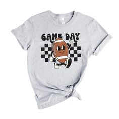 Looking for a cute versatile top to wear this summer? Make sure to grab one of our Football Game Day Checkered tees! This soft and comfortable graphic tee is the perfect top for any outfit. It can be paired with biker shorts, jeans, or even a simple skirt/dress! This tee is true-to-size, so be sure to order your regular t-shirt size! If you are looking for a more oversized look, make sure to size up! Summer Game Day T-shirt With Text Print, Casual T-shirt With Funny Print For Game Day, Graphic Tee With Text Print For Game Day, Graphic Tee T-shirt For Game Day With Text Print, Game Day Graphic Tee With Text Print, Fun Screen Print Tops For Game Day, Fun Game Day Top With Screen Print, Fun Screen Print Top For Game Day, Summer Game Day Cotton T-shirt