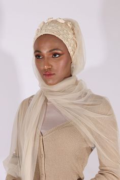 Complete your look with this stunning cream turban veil. Our Mystery in Cream Veil presents this magnificently embroidered turban to frame your face for a distinctive look. The one-piece turban veil is made especially for a simple yet classy fit that you can do yourself. The 58” long veil has a light cream shade to brighten up your dress.Whether it’s your wedding or engagement party, this turban veil will surprisingly shine up your special day and wow your guests.The turban's embroidery is based Elegant White Hijab, Elegant White Headwrap Headband, Elegant White Headband Headwrap, Traditional White Headscarf, Elegant White Headscarf For Wedding, Traditional White Hijab For Wedding, Elegant White Wedding Turban, Elegant White Wedding Headscarf, Elegant Fitted White Turban